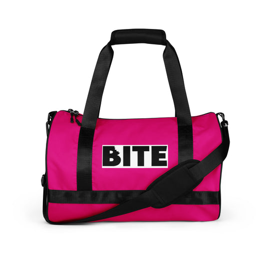 Pink gym bag with black straps and bold lettering